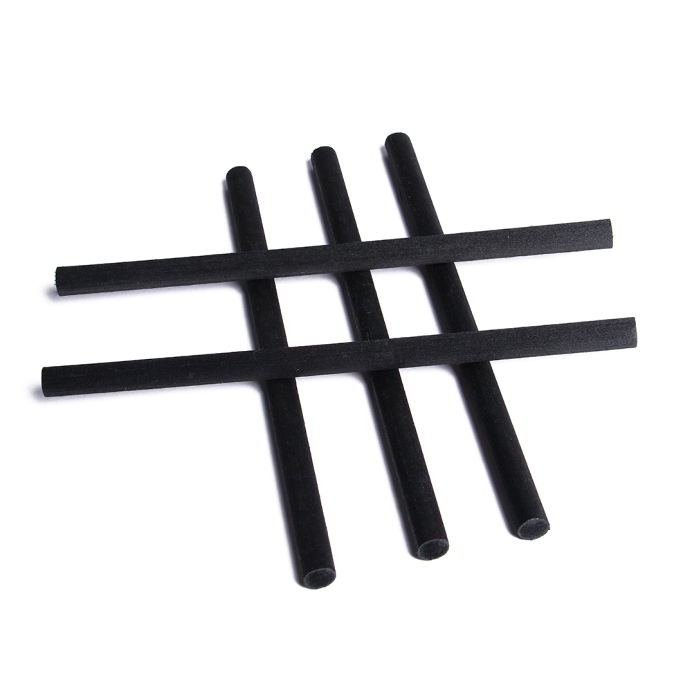 Black fiber diffuser sticks arranged to show their surface and cut ends